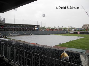 A Lone Stadium Usher Tries In Vain To keep The Rain Away at BB&T Ballpark in Charlotte, North Carolina
